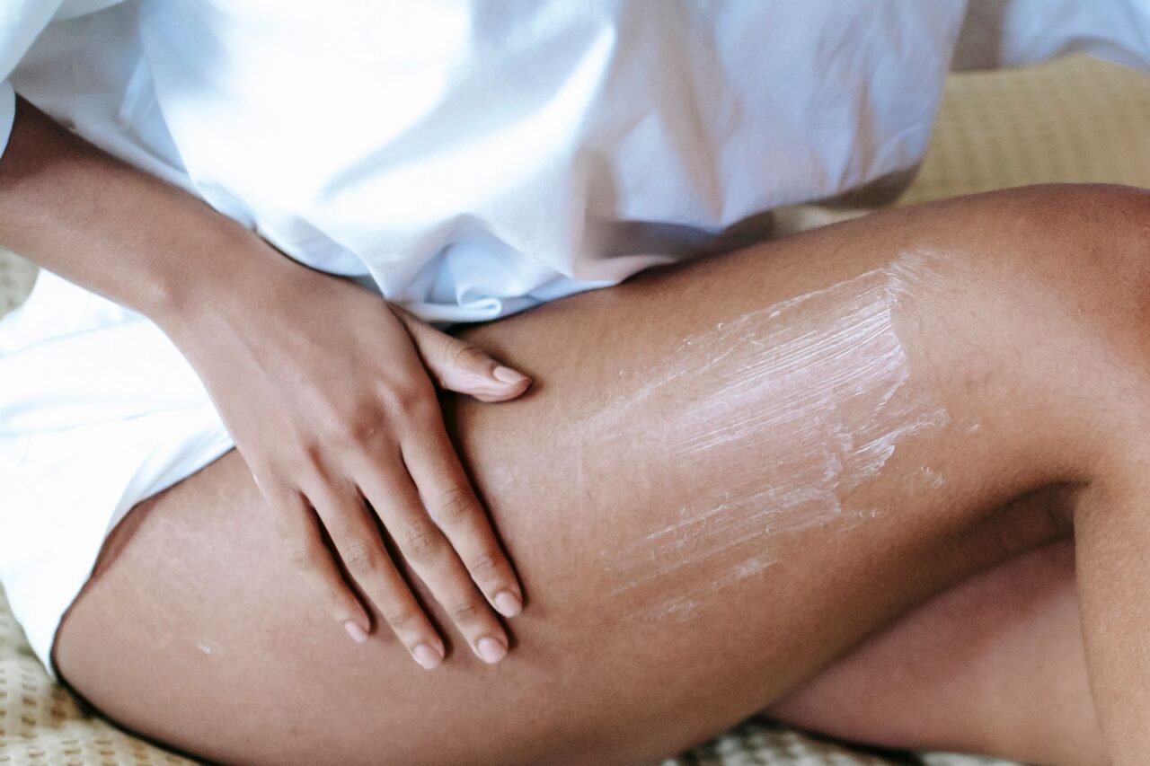 applying magnesium lotion to leg for muscle relief