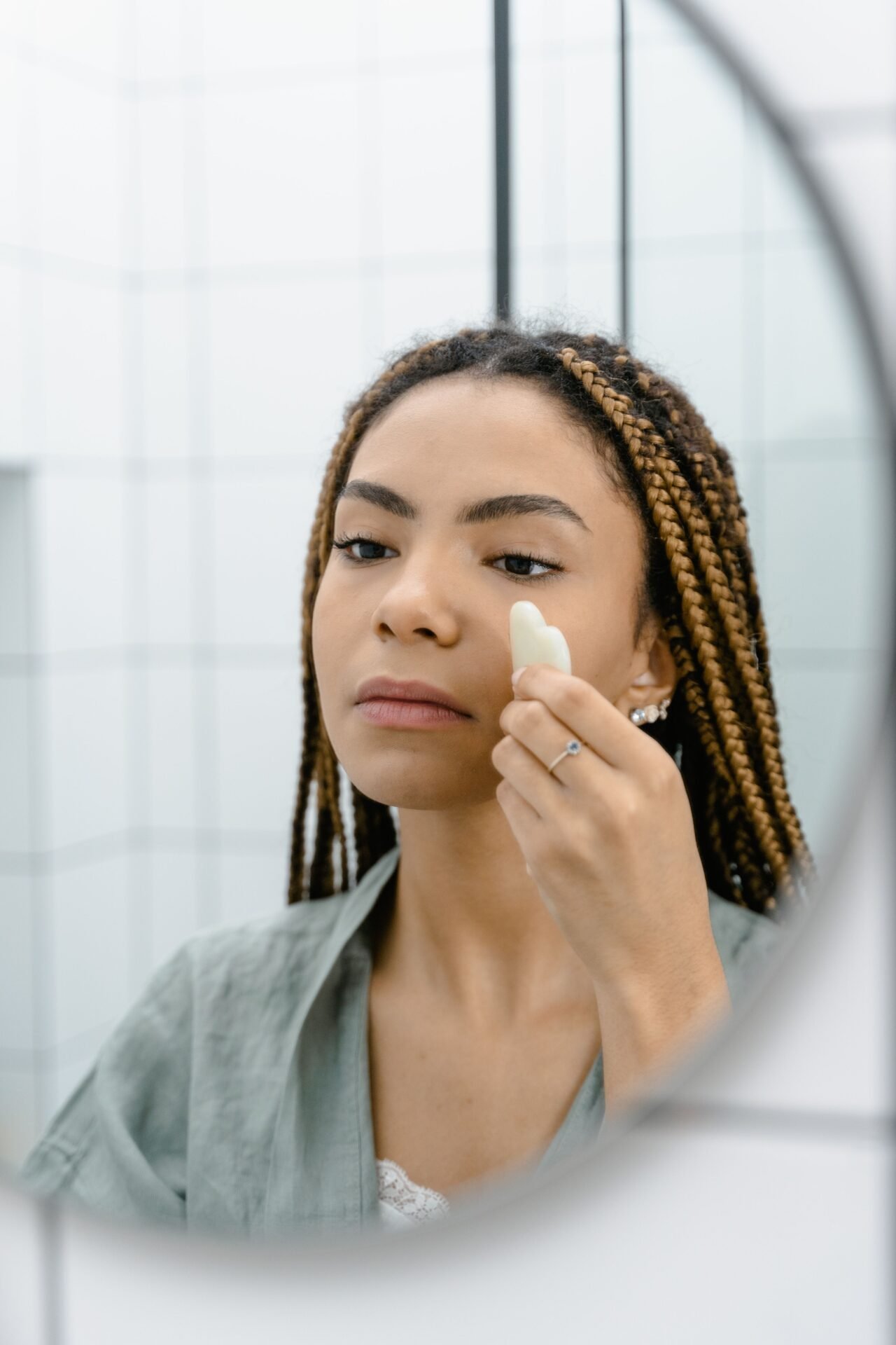 woman doing an at-home beauty routine in front of a mirror