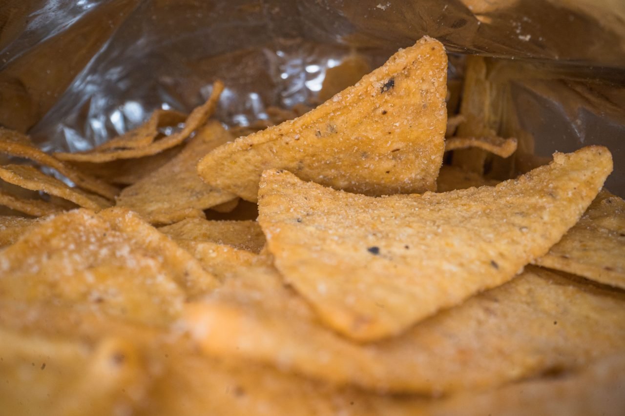 salted tortilla chips inside an open bag
