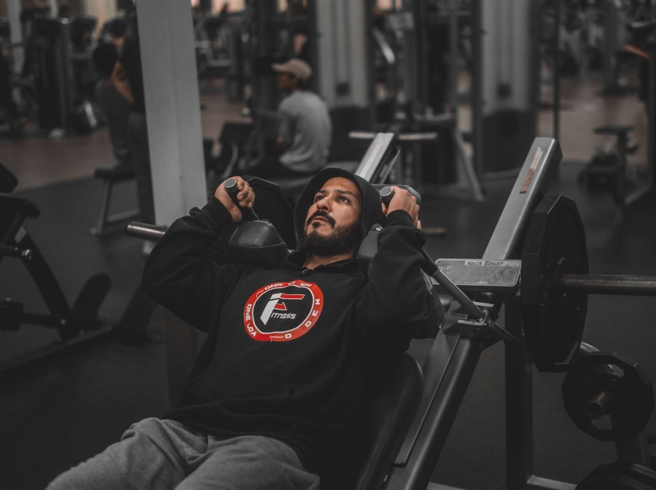 person doing a bench press at the gym