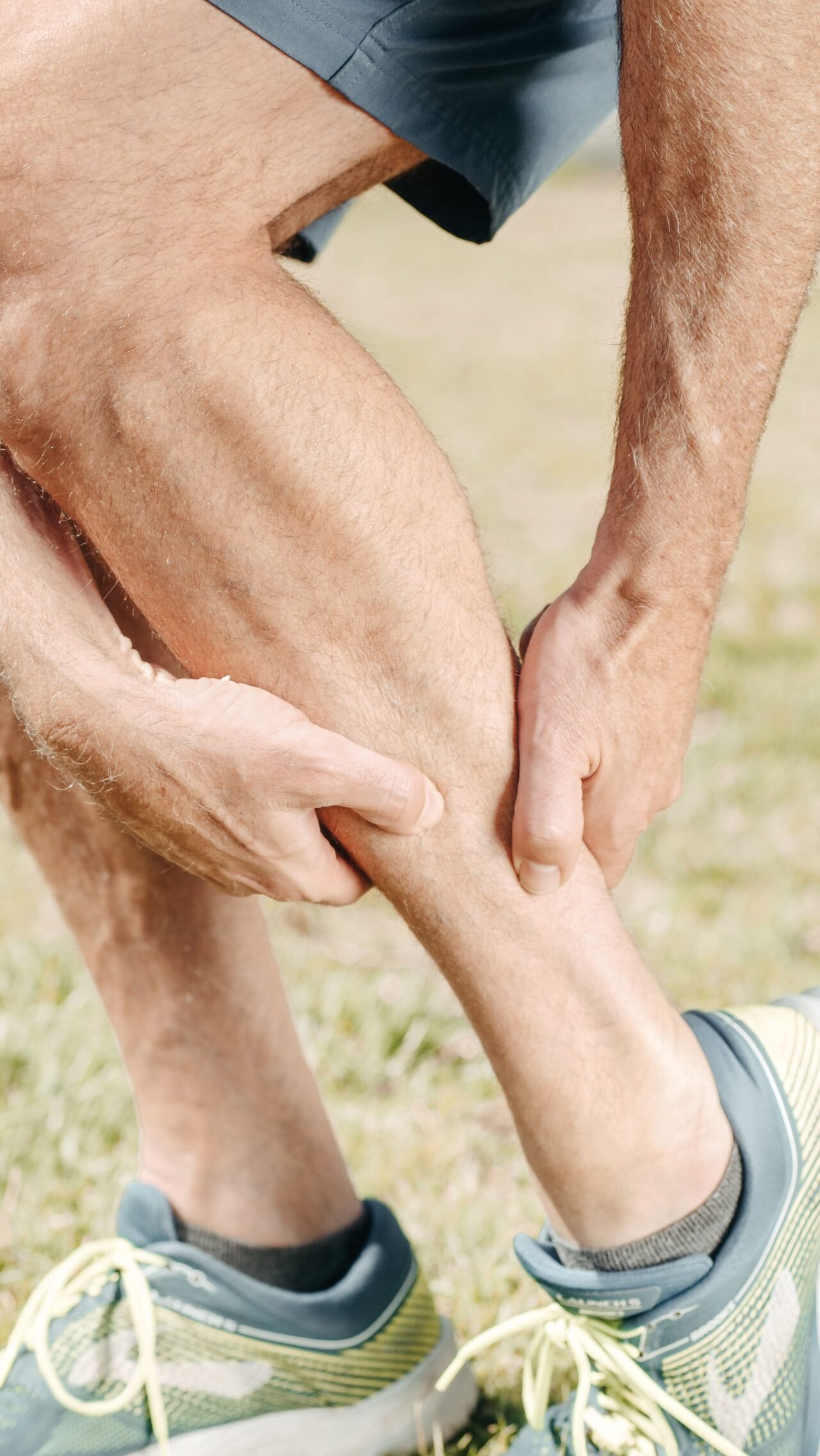 hands massaging calf muscle