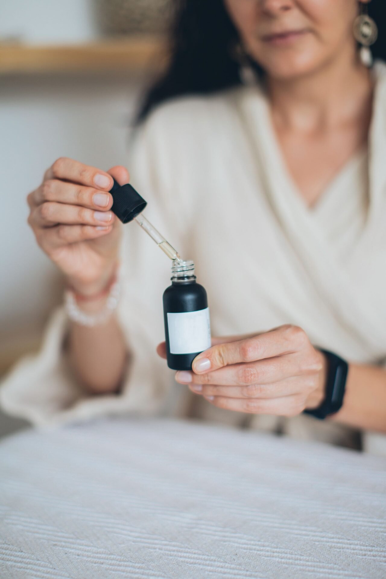holding skincare serum bottle