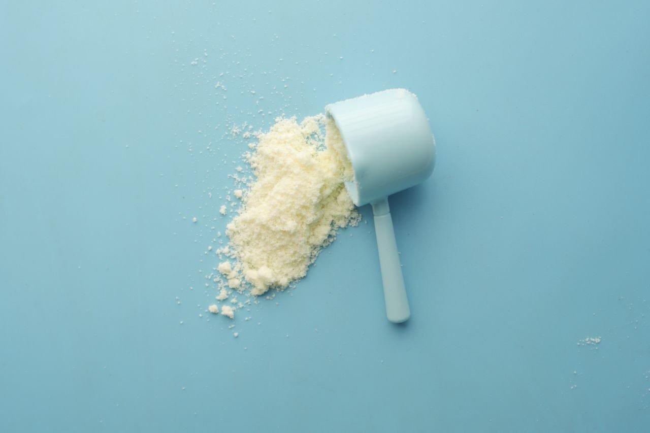 scoop of white powder for measuring a supplement dose