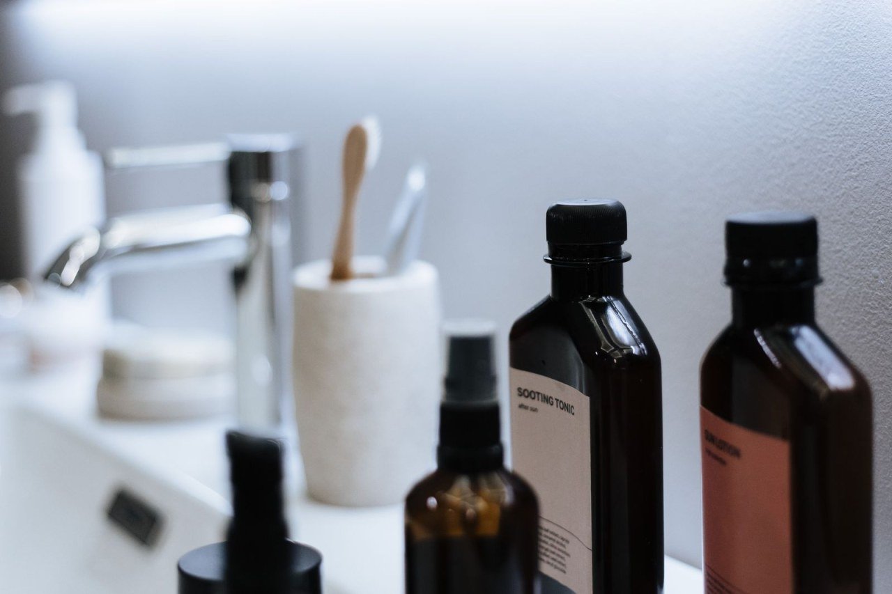 skincare products arranged on a bathroom sink counter