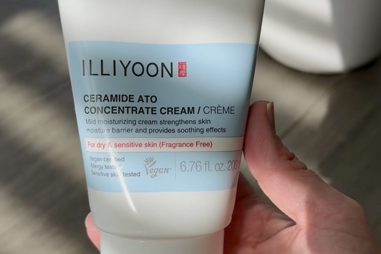 hand holding a tube of Illiyoon Ceramide Ato Concentrate Cream